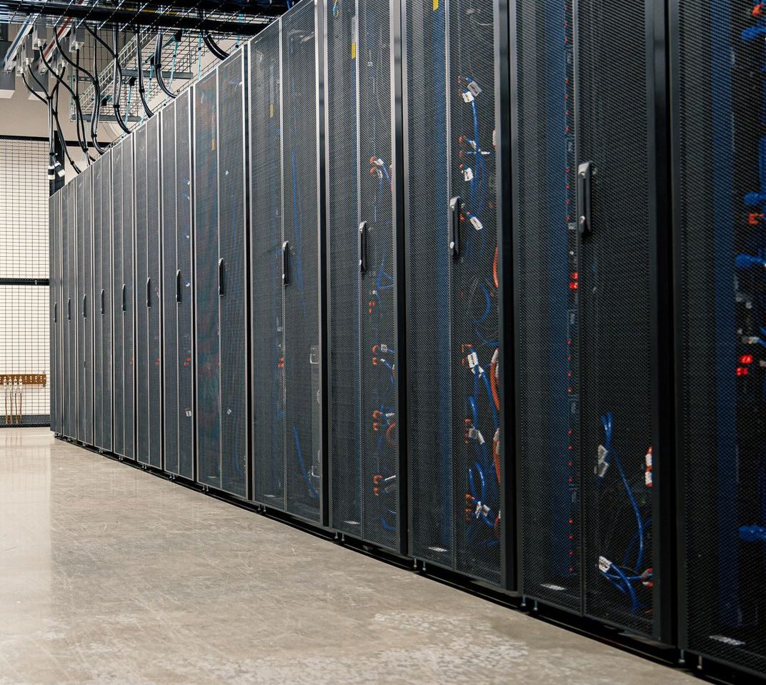 A secure data-center corridor lined with server racks, conveying guarded information.